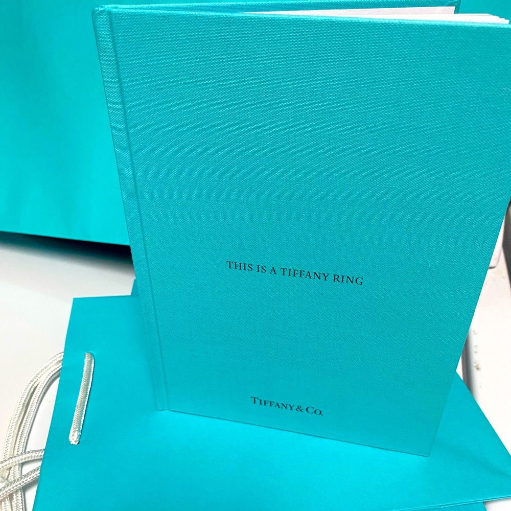 Tiffany & Co. Brand new, “This is a Tiffany Ring” book. Classic blue col…
